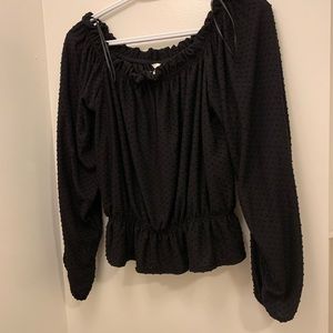 Open shoulder black blouse.